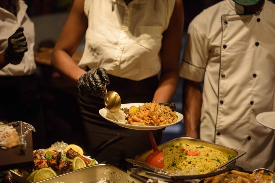 Professional catering staff serving guests with a smile